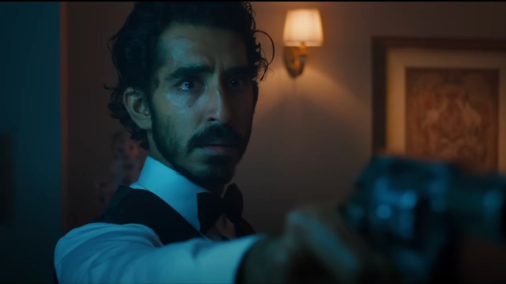 Dev Patel points a gun in Monkey Man.