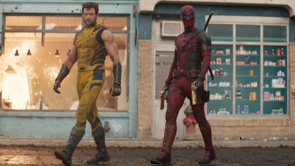 Wolverine and Deadpool walk down the street.