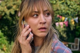 Kaley Cuoco stares while holding a phone to her ear.