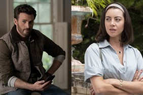 Chris Evans sits on a bed, while Aubrey Plaza stands looking on.