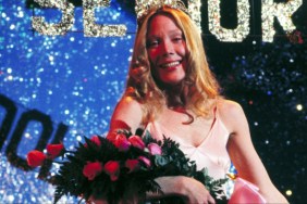 A girl holds up flowers.