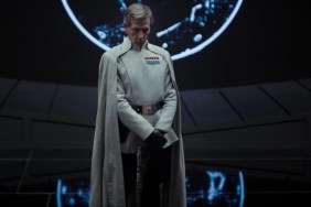 Ben Mendelsohn stands and satres.