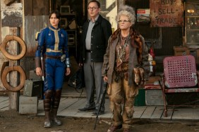 Three peopel stand outside a door in Fallout.