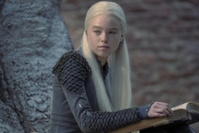 Milly Alcock sits down with a book in House of the Dragon.