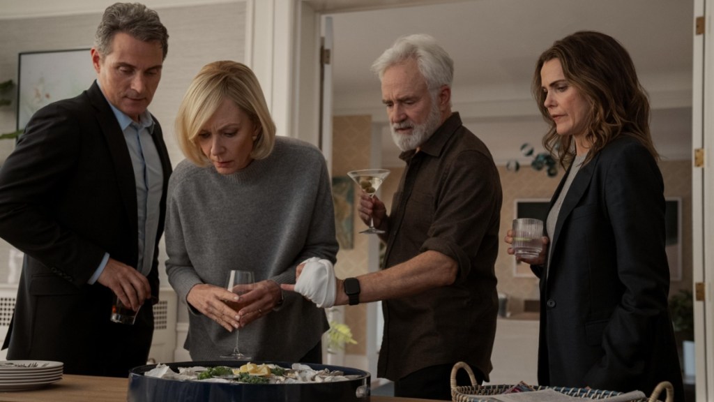 A group of people stand over a table in The Diplomat Season 3.